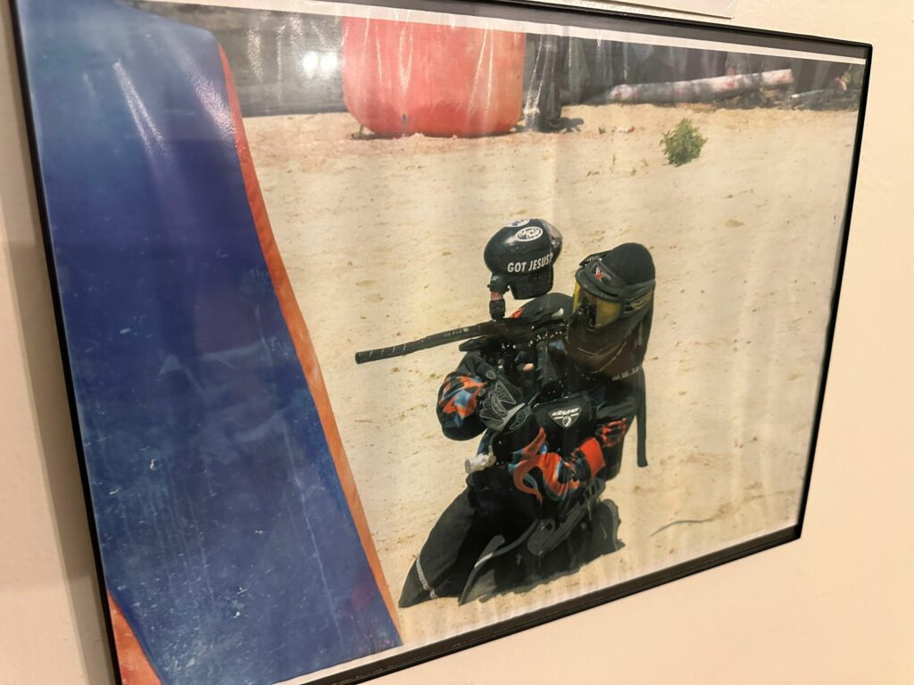 Photo of Rodger Thomas holding paintball equipment.